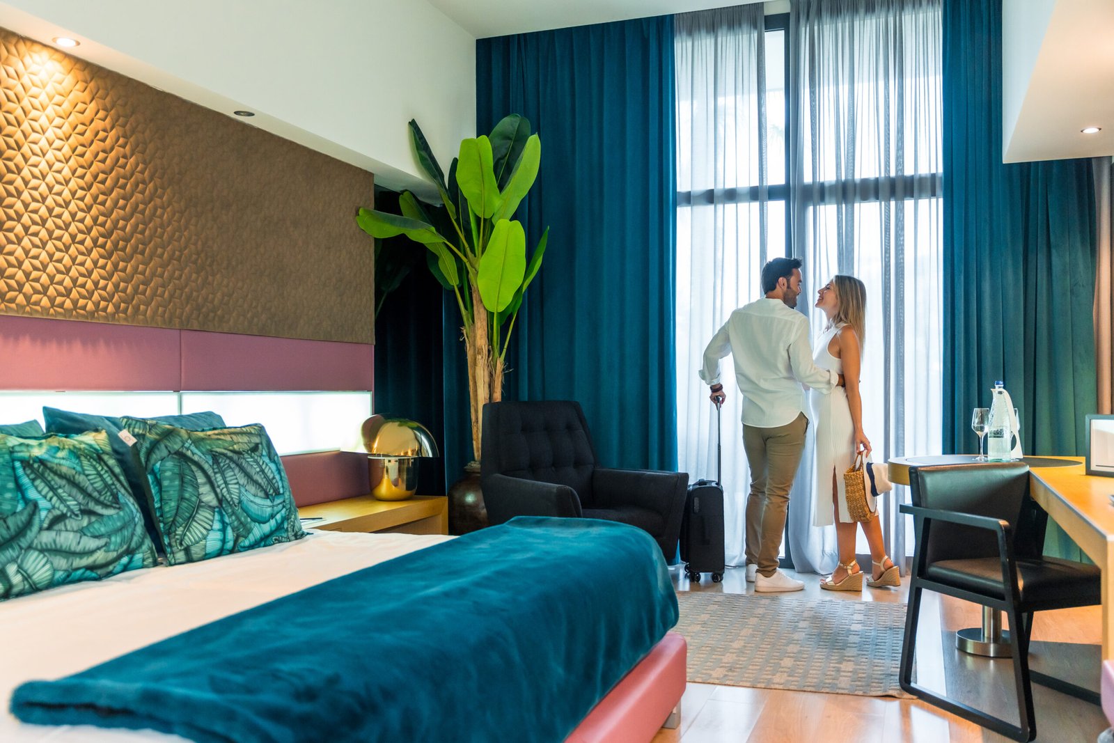 Horizontal photo with copy space of a happy couple kissing in a luxury hotel room upon arrival