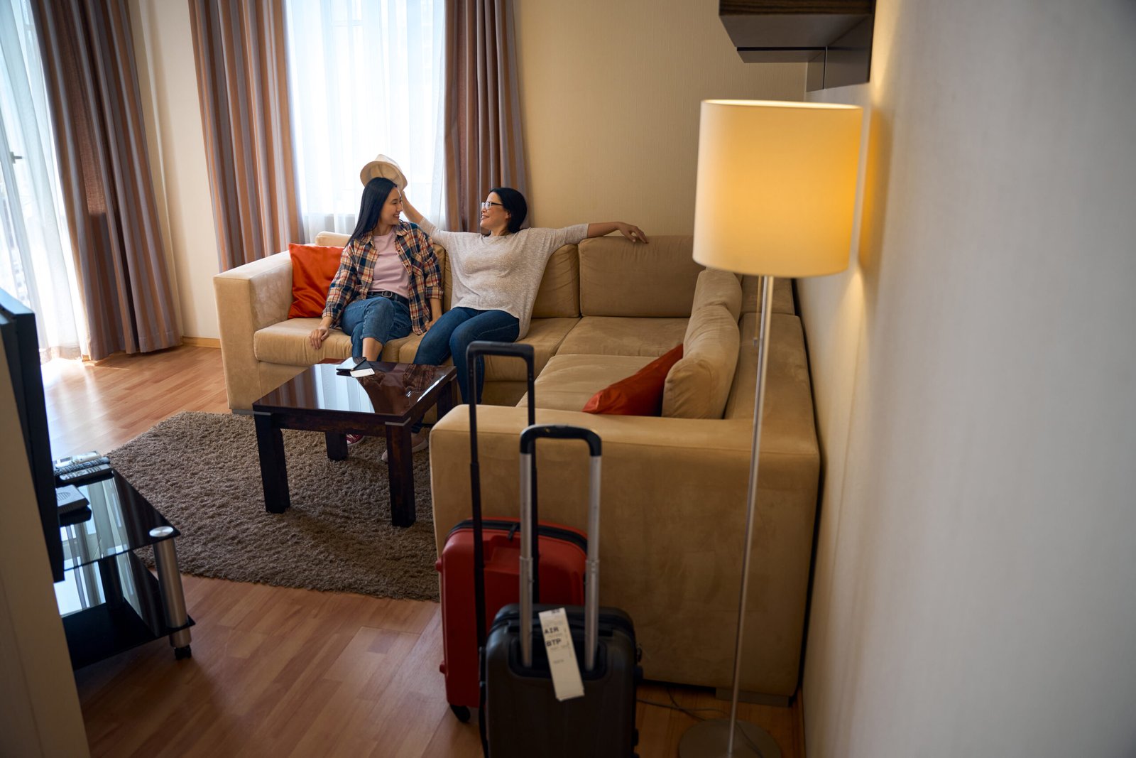 Joyous travelers whiling away time in hotel room on arrival